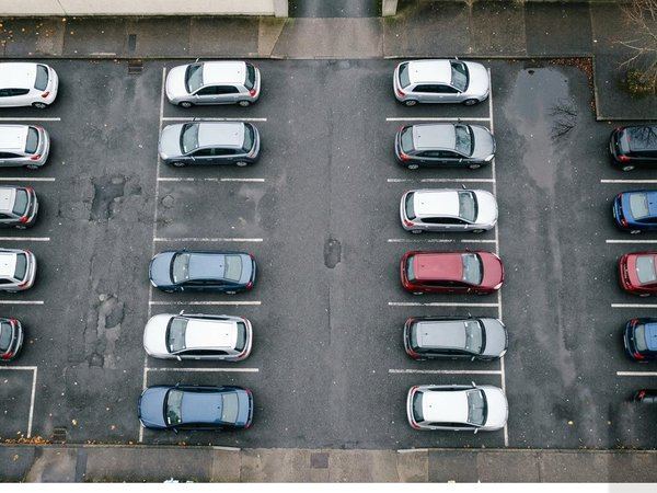 A car park from above with a green box drawn around each car.