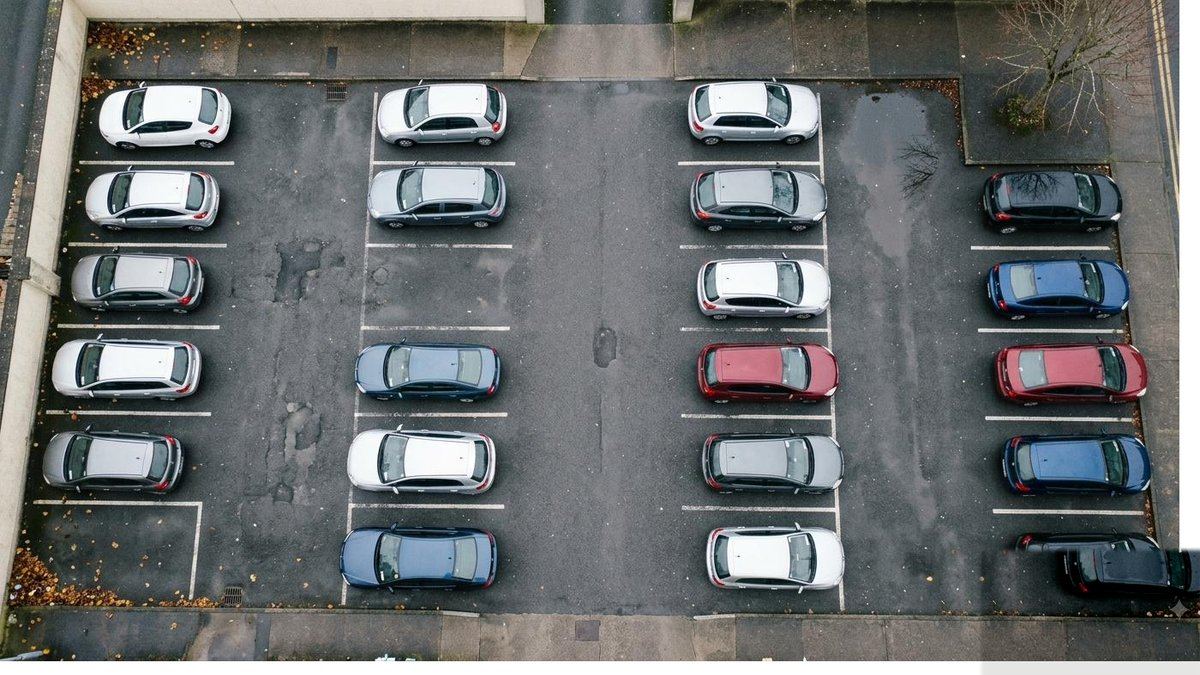 A car park photographed from above with a green box drawn around each car and a number beside it.
